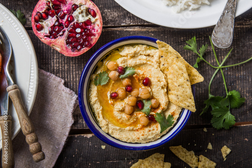 Directly above shot of Hummus or humus In bowl on table. Vegan plant based food photo