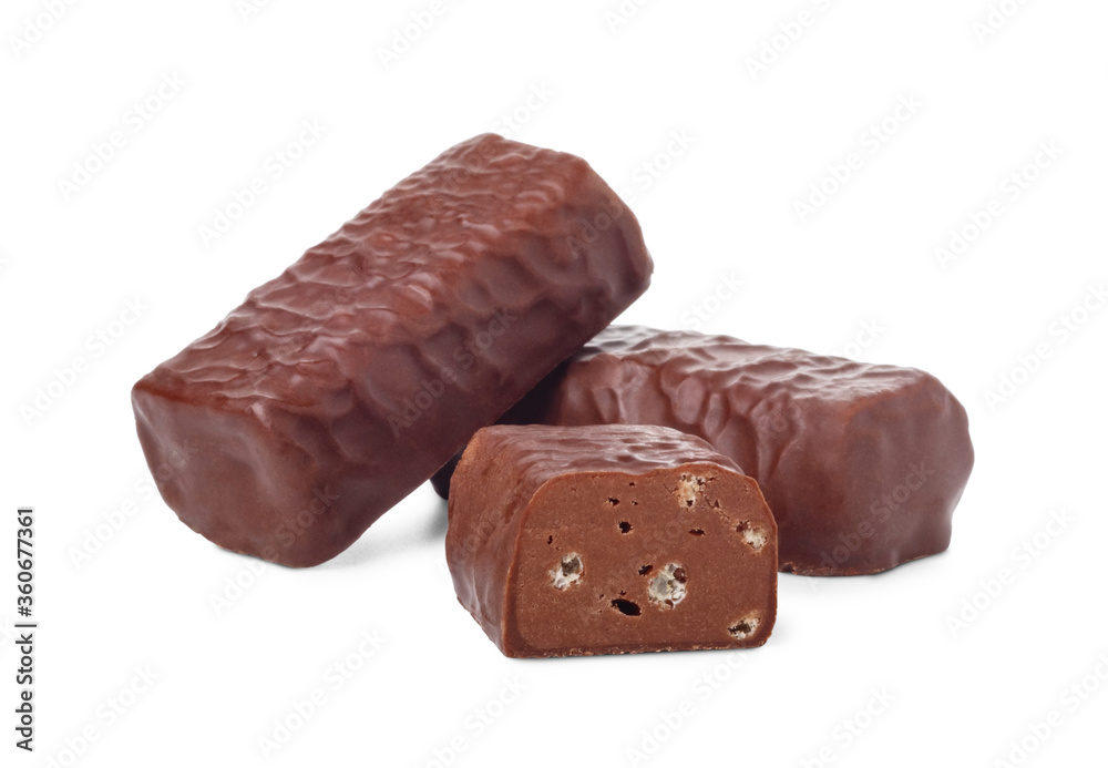 Chocolate candies and candy bar in half isolated on white background. Chocolate candies and candy bar in half isolated on white background.