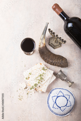 Passover, the Feast of Unleavened Bread, matzah  and  Kosher red wine glasses shofar (horn) with copy space. photo