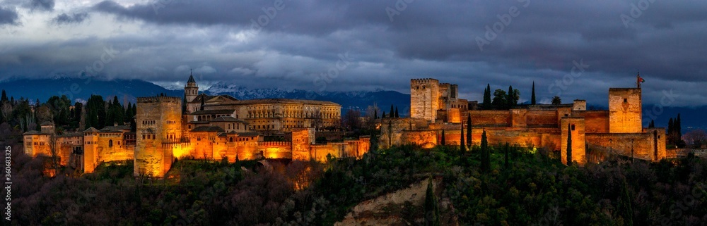 Thunderclouds over the Alhambra. Night panoramic view of Alhambra. Andalusia, Spain