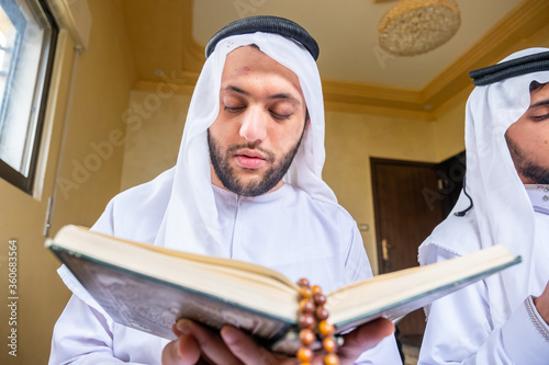 Happy msulim family reading Quran togther photo