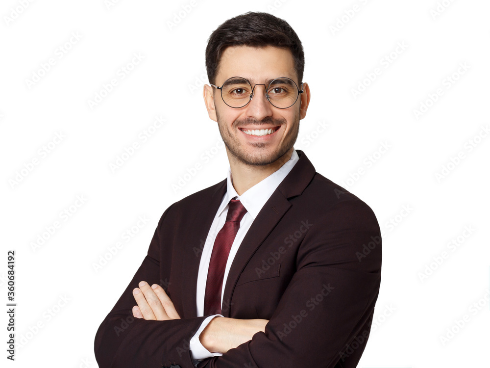 Young businessman in maroon suit, white shirt and red tie looking at camera standing with crossed arms, isolated on gray background Young businessman in maroon suit, white shirt and red tie looking at camera standing with crossed arms, isolated on gray background