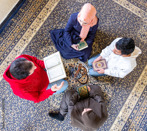 Top view of muslim family members reading quraan together photo