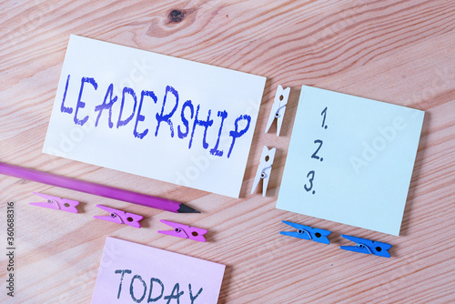 Word writing text Leadership. Business photo showcasing art of motivating to act toward achieving a common goal Colored clothespin papers empty reminder wooden floor background office photo