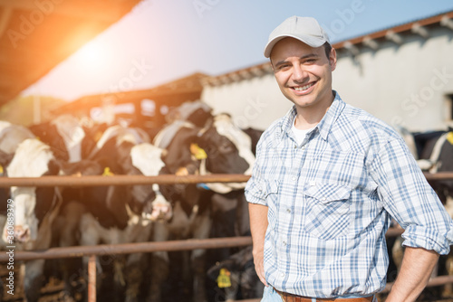Breeder in front of cows photo