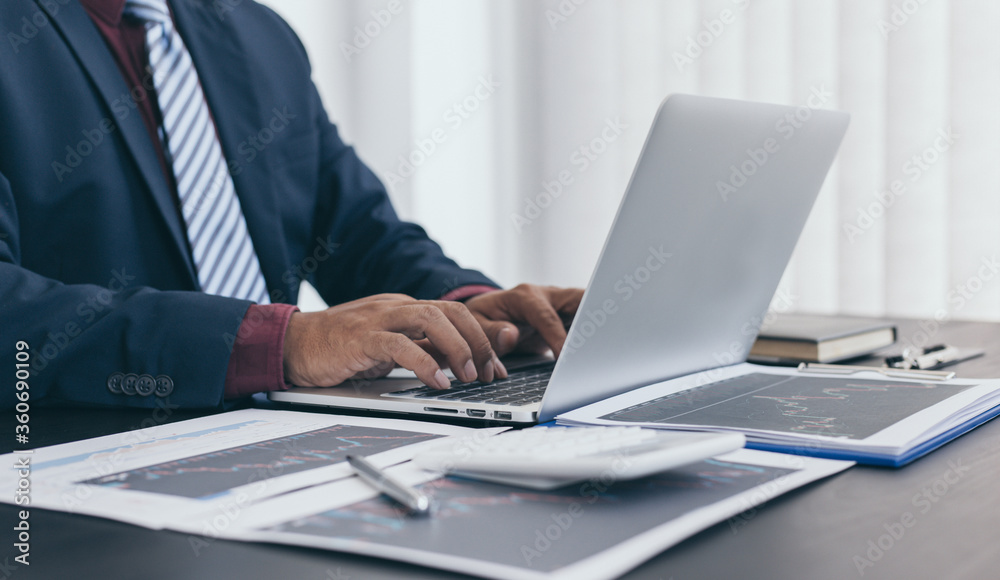 Young black business man sitting and analyzing stock data in the office. Young black business man sitting and analyzing stock data in the office.