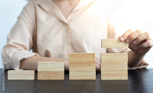 Asian woman following a domino on the steps.