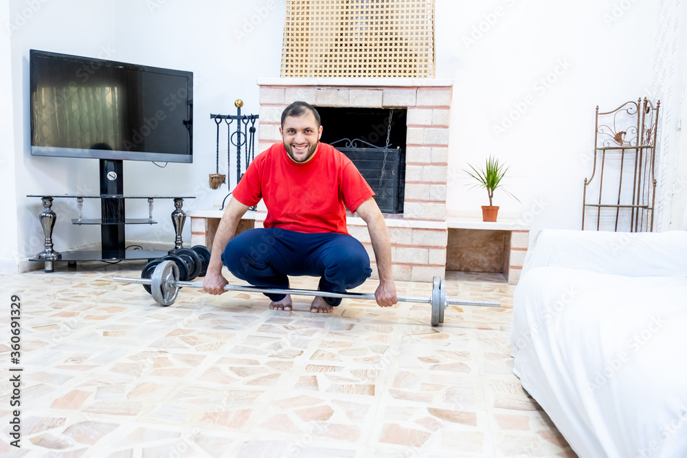 Athletic guy training hard at his home Athletic guy training hard at his home
