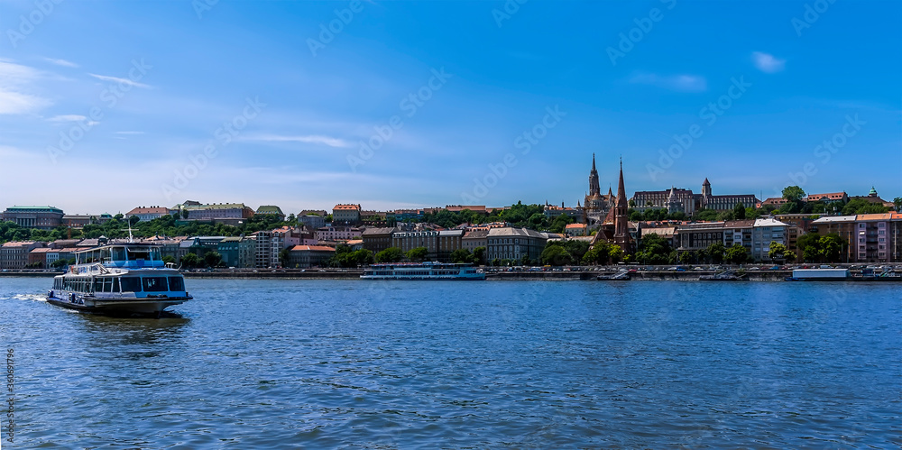 River ferry on the Danube in Budapest with the Castle District in the background during summertime