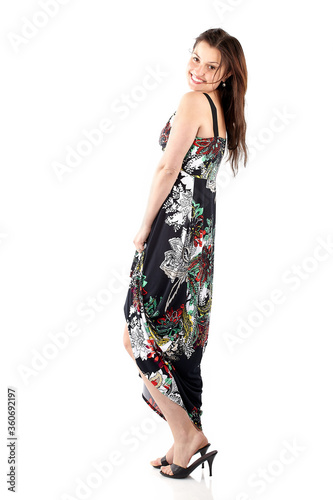 Beautiful young woman in sundress with colorful flower pattern, full body on white background
