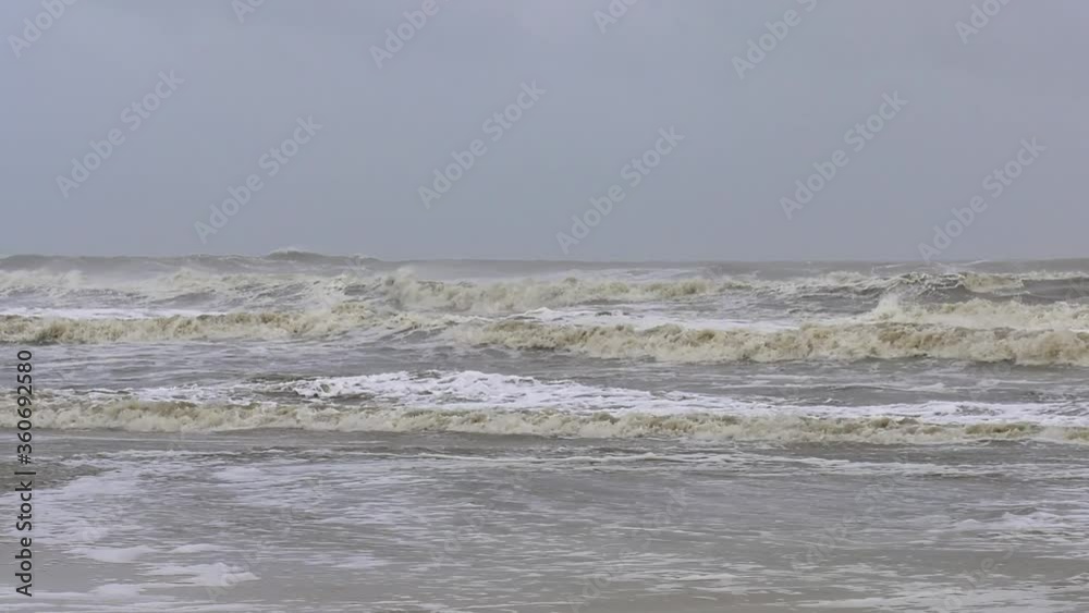 Strong waves strike a beach during a tropical storm Strong waves strike a beach during a tropical storm