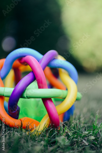 Colorful plastic baby toy on the grass