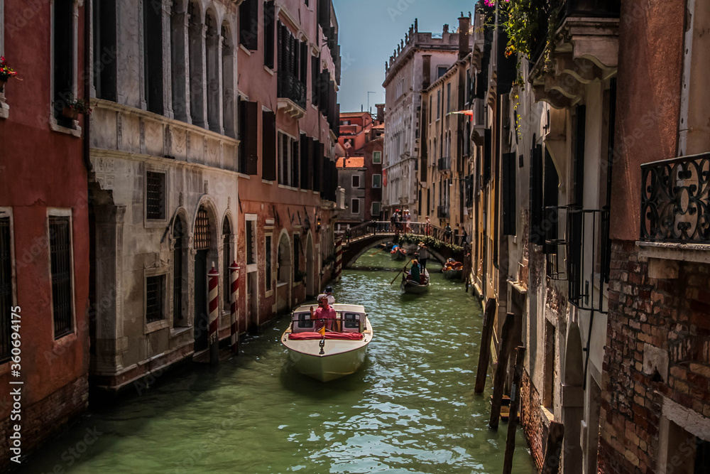 Amazing view on the beautiful Venice, Italy. Many gondolas sailing down one of the canals.