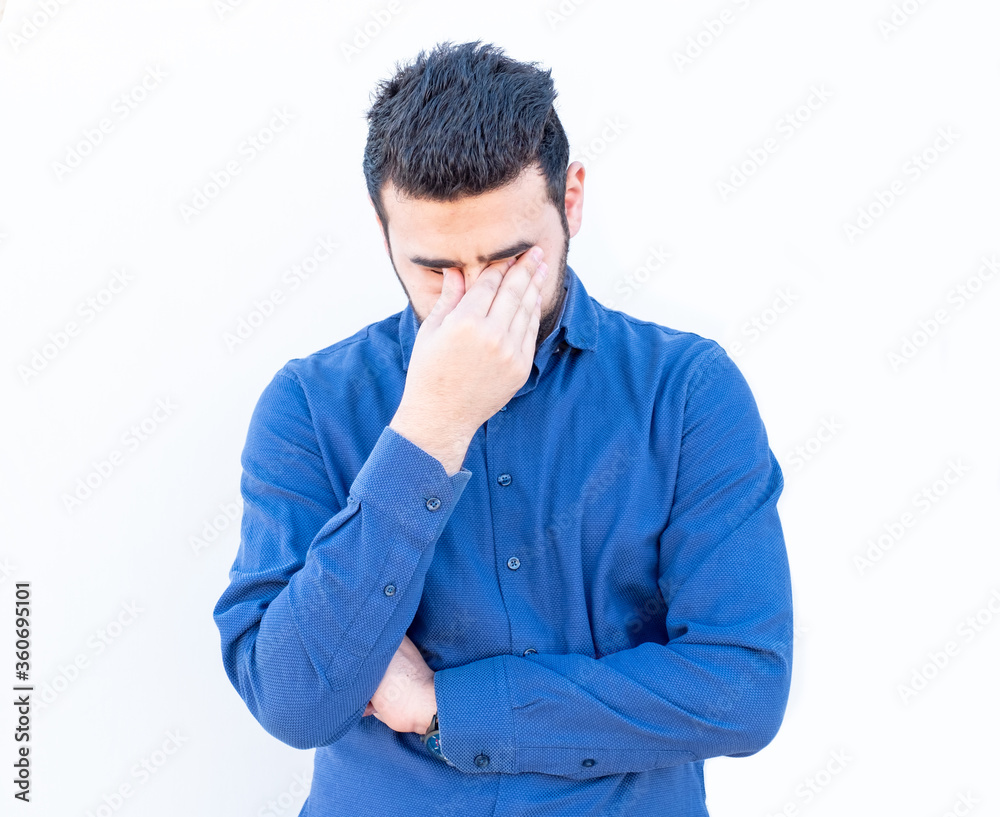 Arabic guy feeling angry and holding his eyes with his hand Arabic guy feeling angry and holding his eyes with his hand