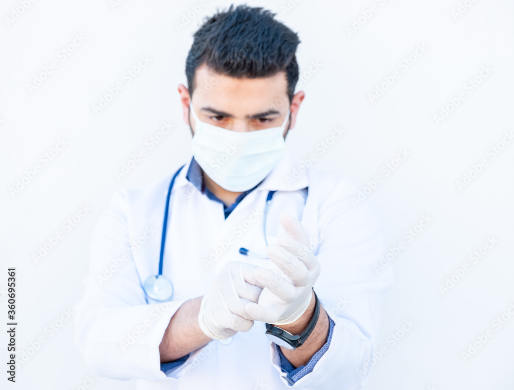 Arabic doctor wearing gloves to protect him self from infection
