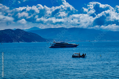 Fisherman boat and large yacht in Portofino Liguria Italy © Paolo Borella