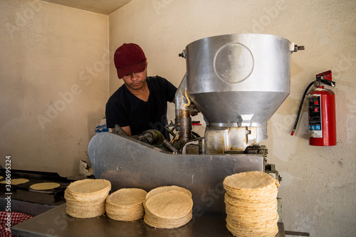 young man selling tortillas of nixtamal