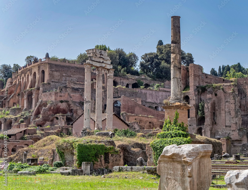 Rome Italy, three columns of the Dioscouroi temple and  Domus Tberiana  in the Roman forum
