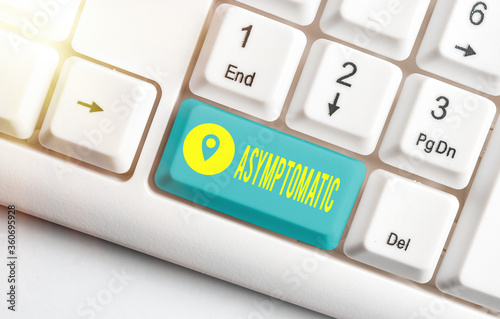 Word writing text Asymptomatic. Business photo showcasing a condition or an individual producing or showing no symptoms White pc keyboard with empty note paper above white key copy space photo