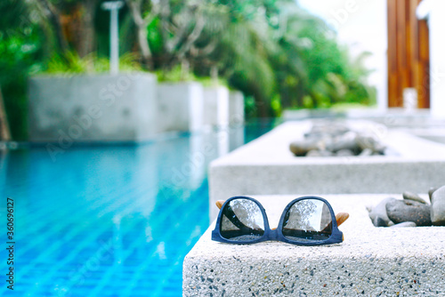 Sunglasses with background  swimming pool, picture have space for idea. photo