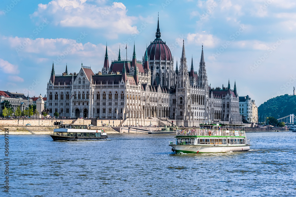 Ferry boats and the view down the east bank of the River Danube in Budapest during summertime