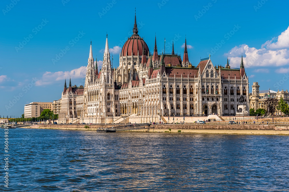 Fototapeta premium A view of the Parliament building on the eastern shore of the River Danube in Budapest from a ferry boat in the summertime