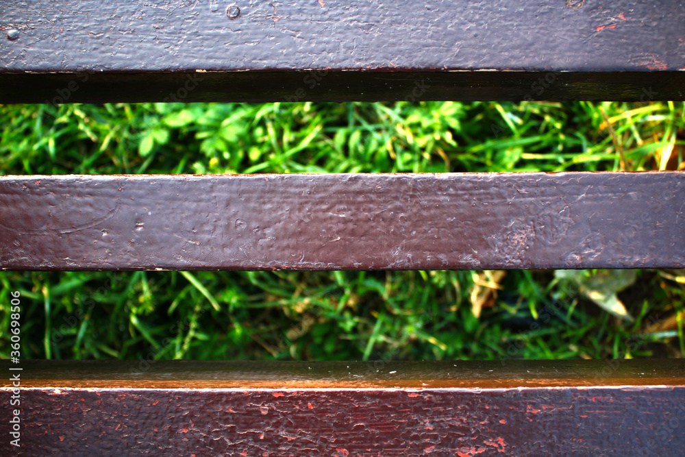 Background, texture, substrate. Wooden bench and green grass Background, texture, substrate. Wooden bench and green grass