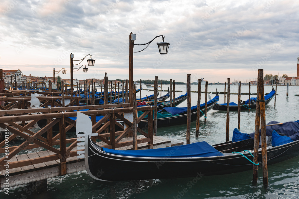 Gondolas anchored by Piazza San Marco with San Giorgio di Maggiore church in Venice,