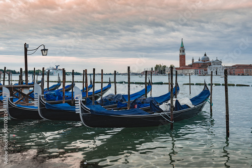 Gondolas anchored by Piazza San Marco with San Giorgio di Maggiore church in Venice, © Antonello 