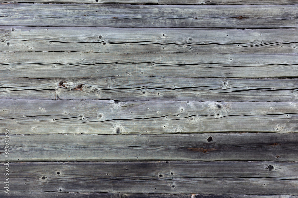 Wooden wall made of gray logs. Wooden wall made of gray logs.
