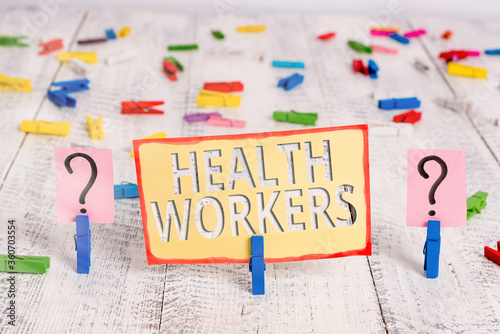 Word writing text Health Workers. Business photo showcasing showing whose job to protect the health of their communities Scribbled and crumbling sheet with paper clips placed on the wooden table