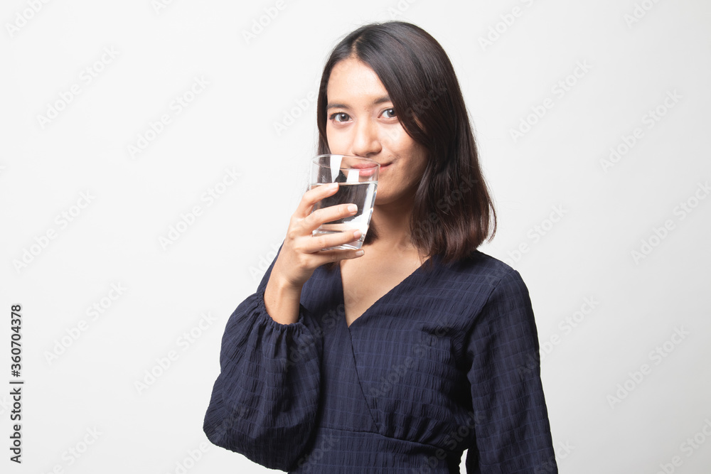 Young Asian woman with a glass of drinking water. Young Asian woman with a glass of drinking water.
