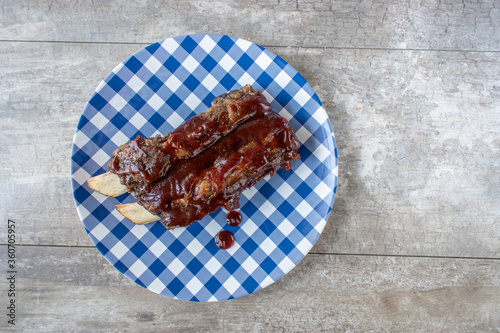 Tela fun picnic plate with beef ribs covered in barbecue sauce flat lay