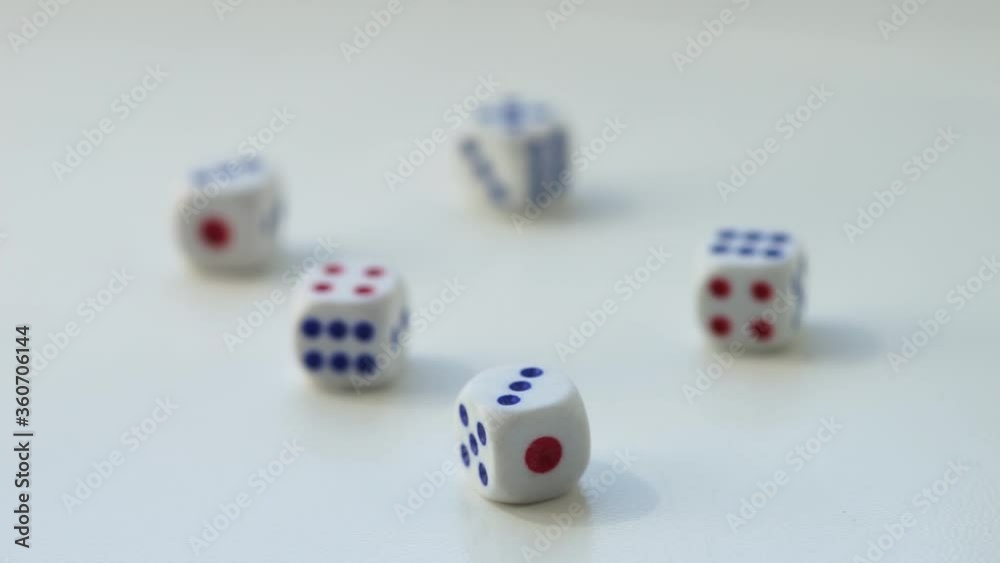 Five dice with different numbers on a white table. Side view Five dice with different numbers on a white table. Side view