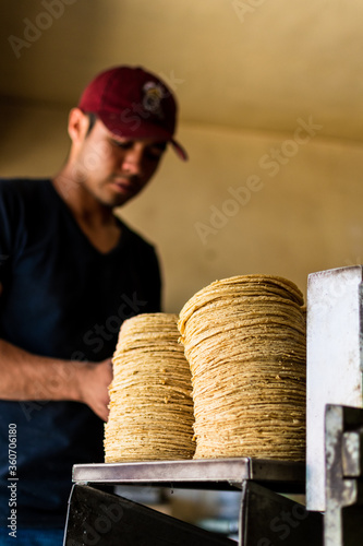 young man selling tortillas of nixtamal photo