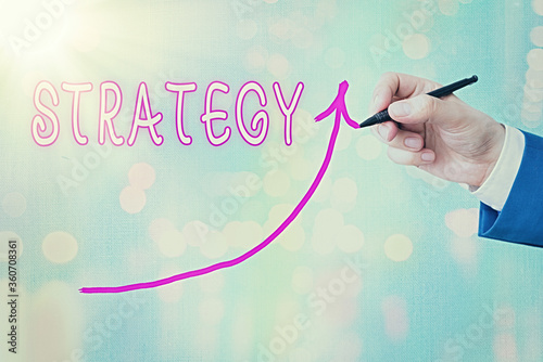 Writing note showing Strategy. Business concept for action plan or strategy designed to achieve an overall goal Digital arrowhead curve denoting growth development concept photo