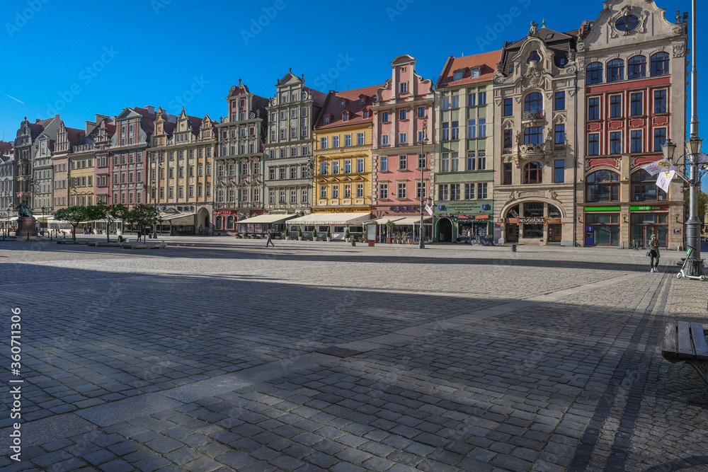 Market Square, Wroclaw, Poland - April 21, 2019: Central square in Wroclaw Old Town since the Middle Ages, surrounded by ornamented and colorful frontages of historical tenement houses.
