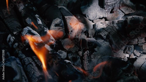 Burning and smoldering coals in a fire.