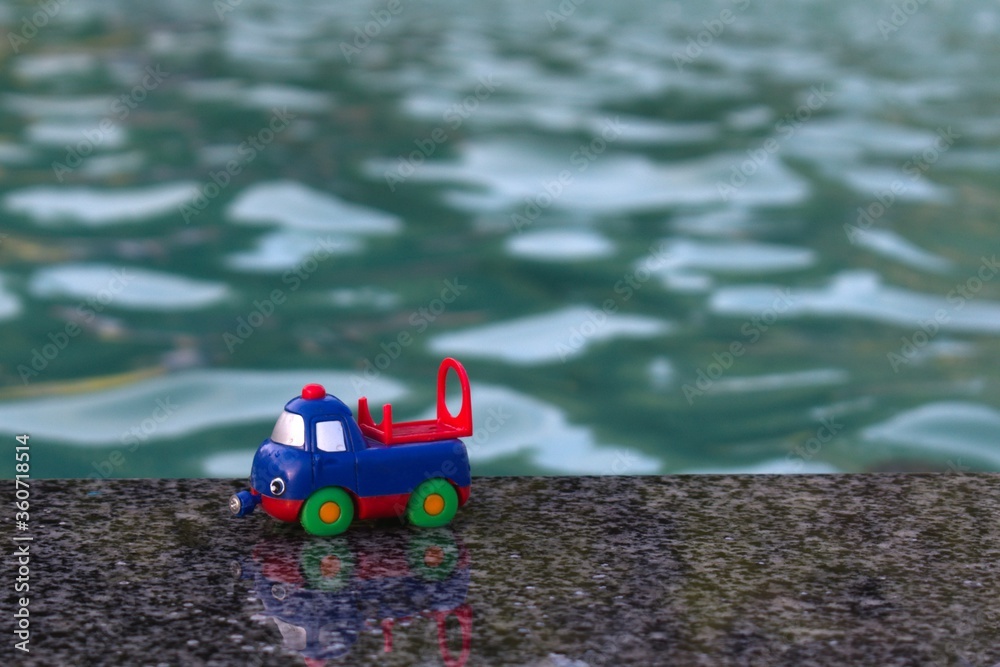 toy car forgotten on the edge of fountain toy car forgotten on the edge of fountain