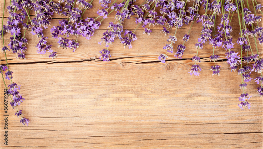 Lavender flowers on wooden background. Greeting card, top view, flat lay, copy space for text Lavender flowers on wooden background. Greeting card, top view, flat lay, copy space for text