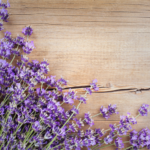 Lavender flowers on wooden background. Greeting card, top view, flat lay, copy space for text
