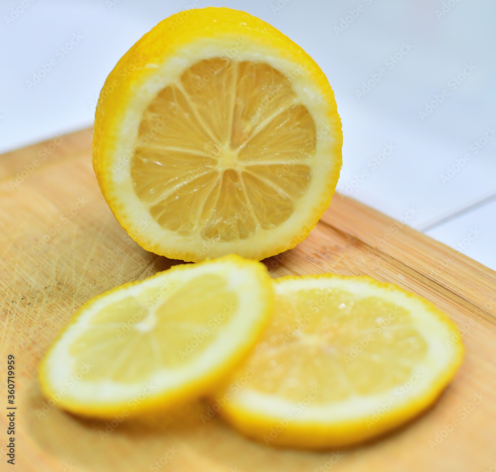 Lemon cut on a wooden board Lemon cut on a wooden board
