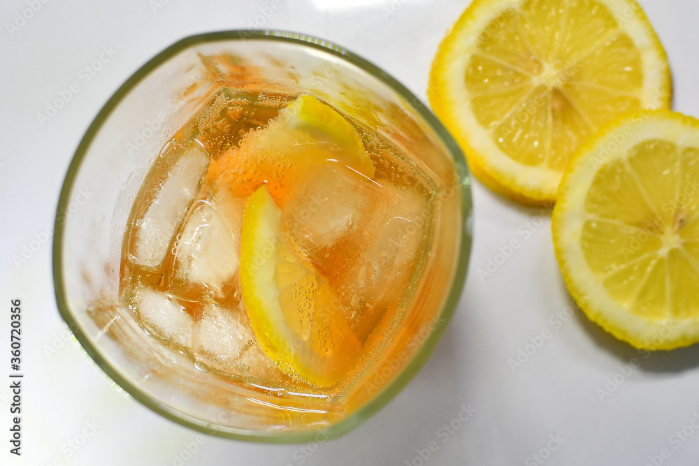 Refreshing light delicious summer aperol cocktail with ice and lemon in a glass isolated on white Refreshing light delicious summer aperol cocktail with ice and lemon in a glass isolated on white
