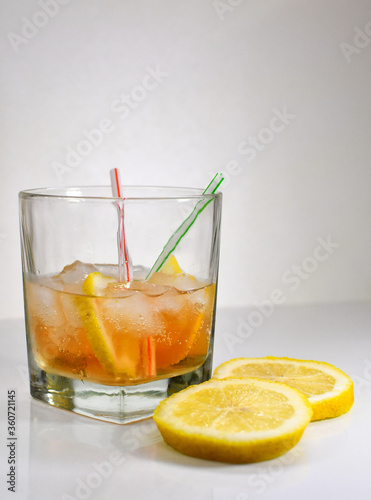 Refreshing light delicious summer aperol cocktail with ice and lemon in a glass isolated on white