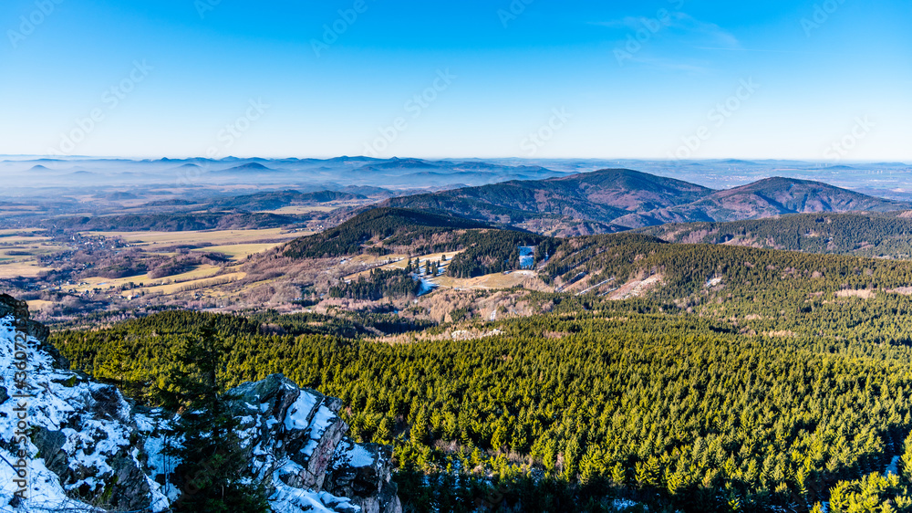 Lusatian Mountains, Czech: Luzicke hory, panoramic view of hilly landscape from Jested Mountain on sunny freezy day