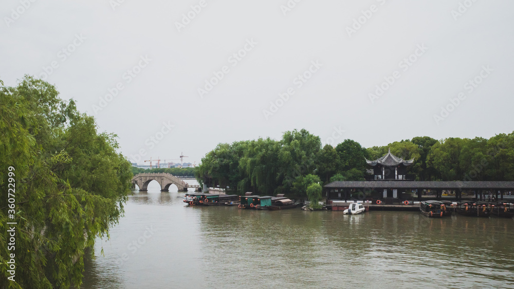 Fototapeta premium Bridge and boat dock in South Lake scenic area in Jiaxing, China