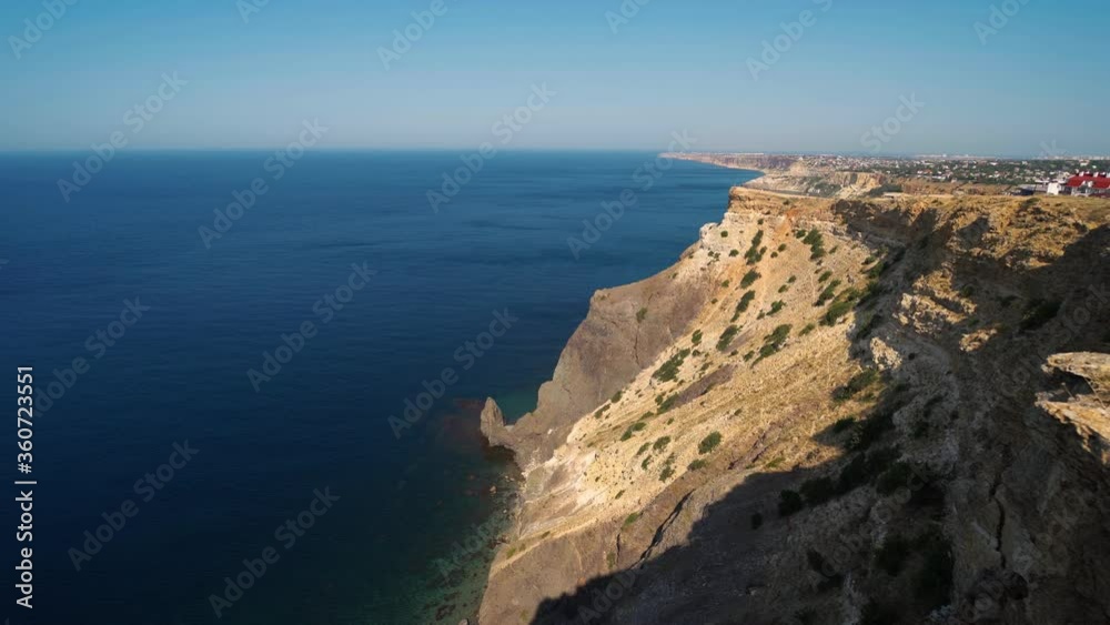 aerial pan view amazing seashore with high limestone cliffs over deep blue sea at sunny summer day. beauty of live nature aerial pan view amazing seashore with high limestone cliffs over deep blue sea at sunny summer day. beauty of live nature