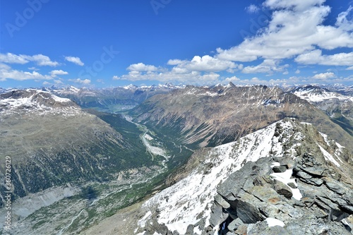 the morteratsch valley from above on a summer day with blue sky photo