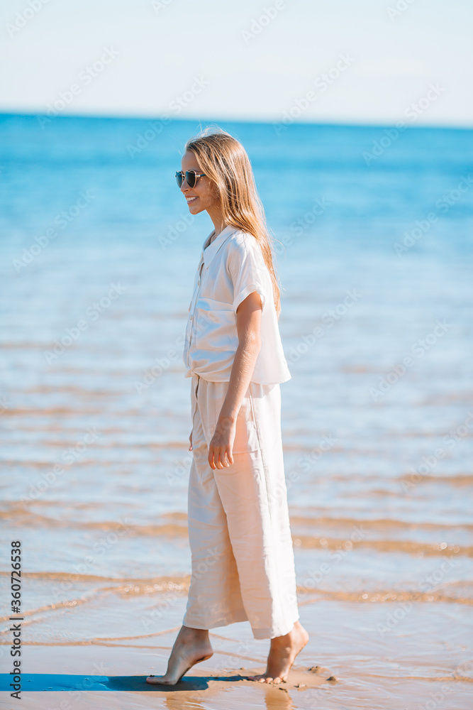 Adorable little girl at beach during summer vacation Adorable little girl at beach during summer vacation