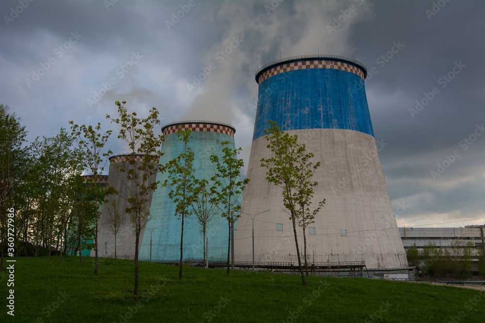 Cooling towers of a thermal power plant on a sunny summer day. Cooling towers of a thermal power plant on a sunny summer day.